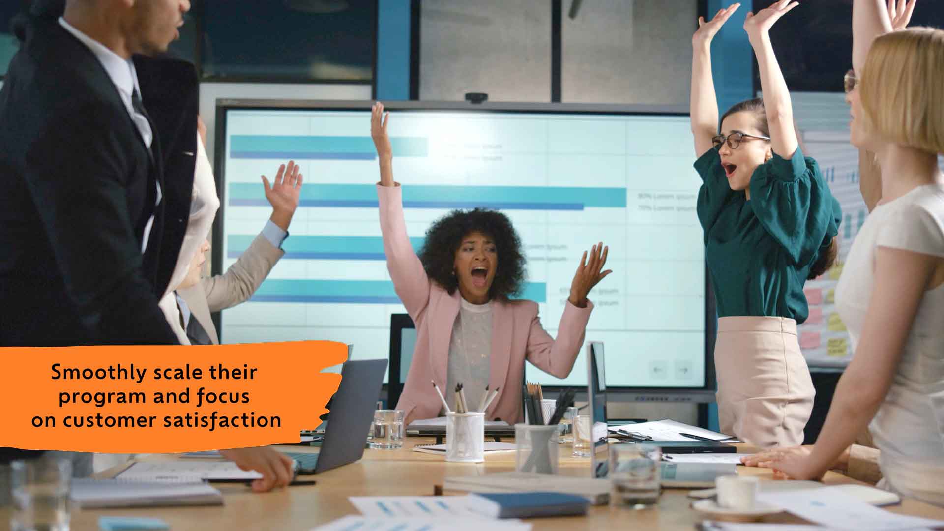 A group of people celebrating in a work conference room.