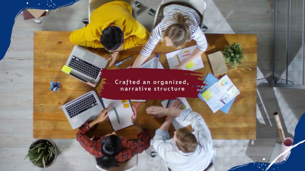 Overhead view of creative people working at a table with their laptops.